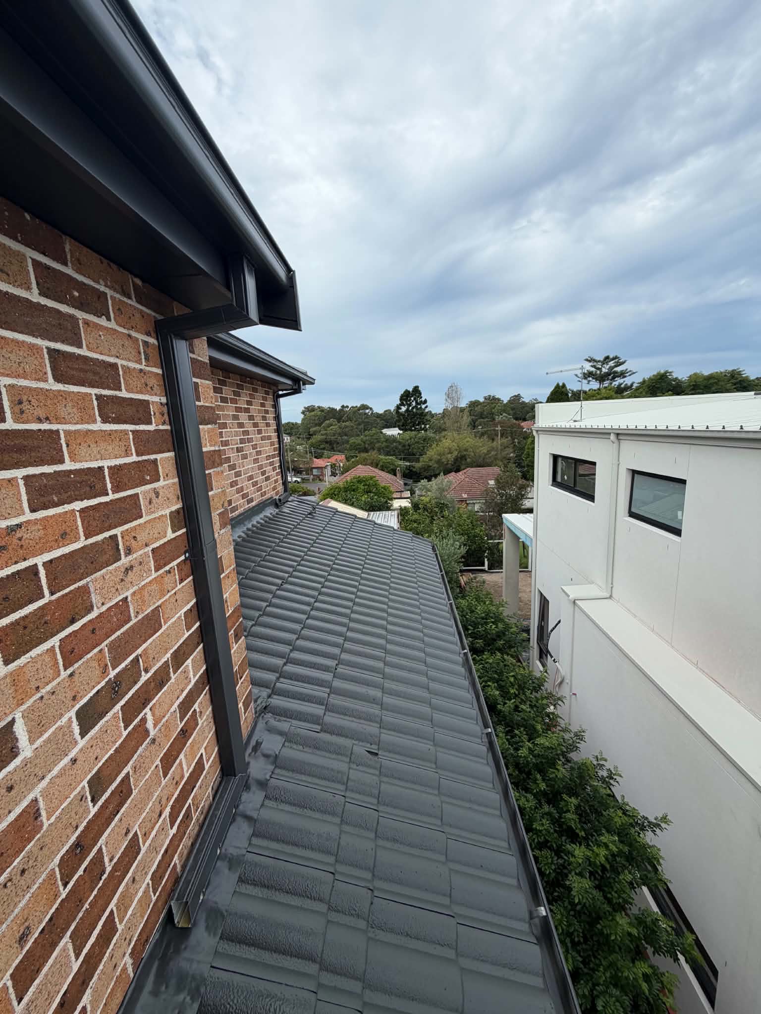 The same roof section after restoration, recoated in charcoal