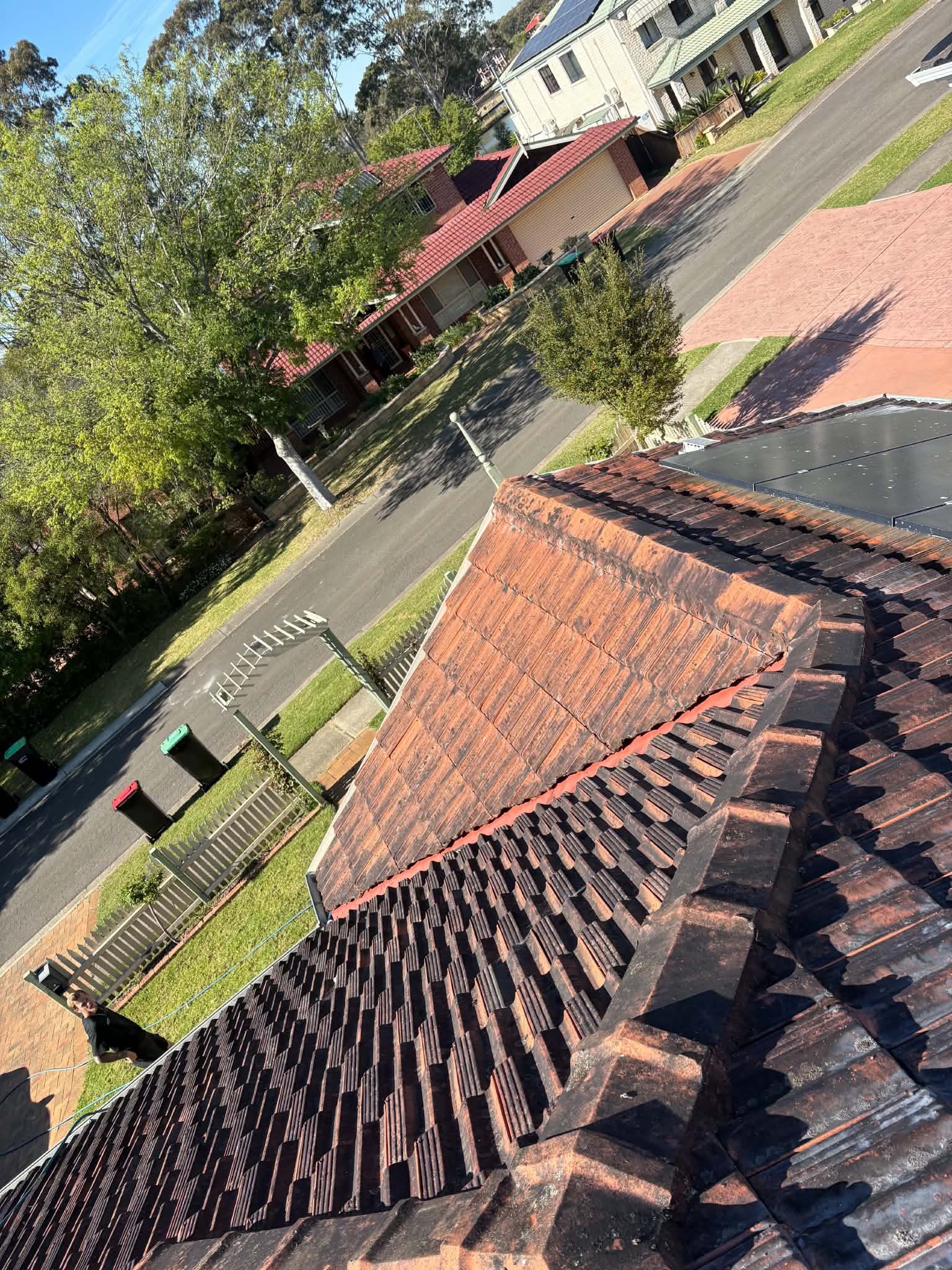 Weathered, worn roof tiles along a ridge, showing their age
